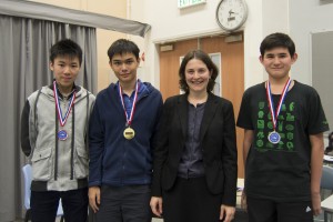 Hong Kong History Bee Championships Medalists from March 7 included from left, bronze medalist Timothy Li of International Christian School, gold medalist Bryan Huang of Renaissance College, IHBB Executive Director Nolwenn Madden, and silver medalist Jeremy Salkeld of German Swiss International School. Photo courtesy of host school coach Jonathan Mok of Creative Secondary School